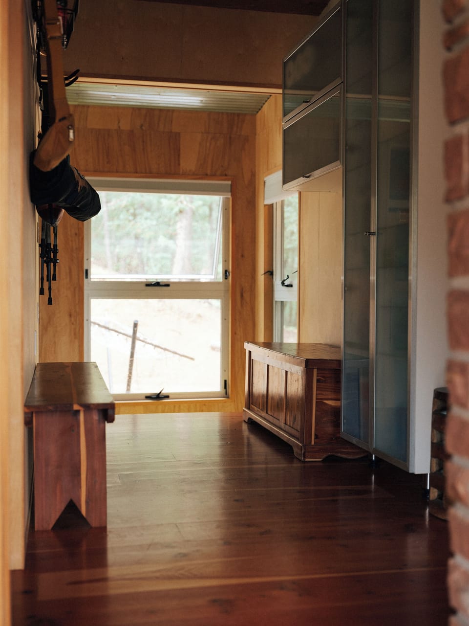 Architectural birch wood paneling and stone brickwork connecting the home.
