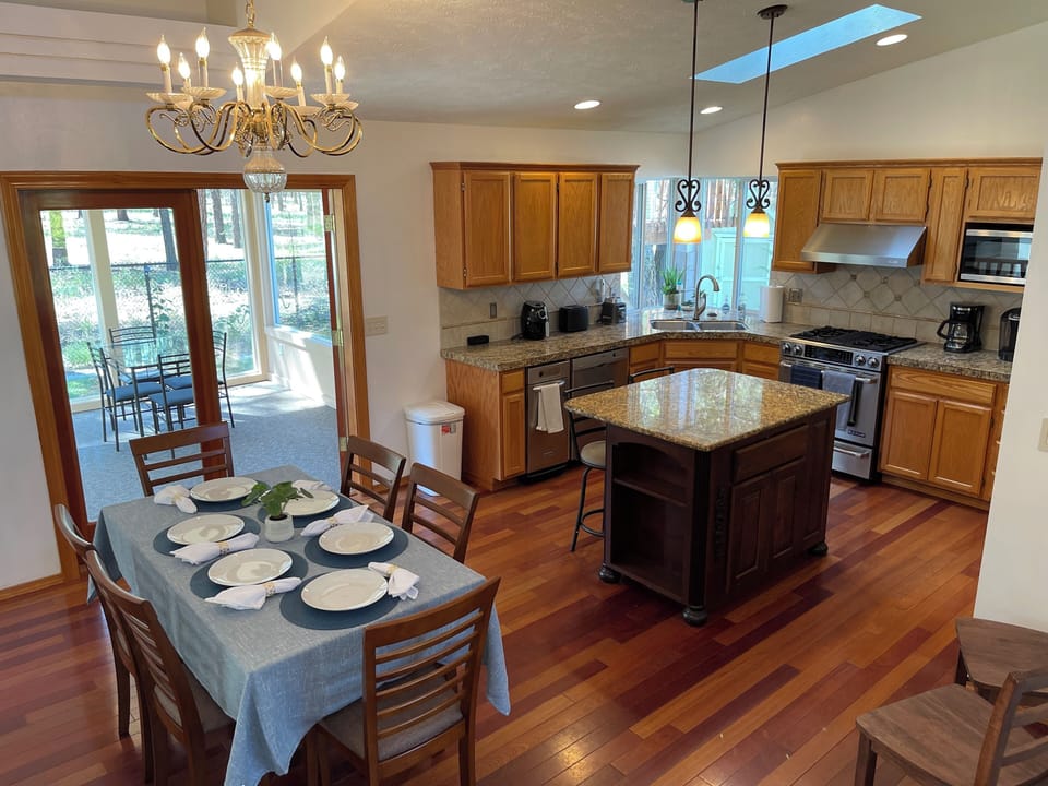 CHEF'S KITCHEN-  Professional S/S appliances.  Glass doors lead to Sunroom.