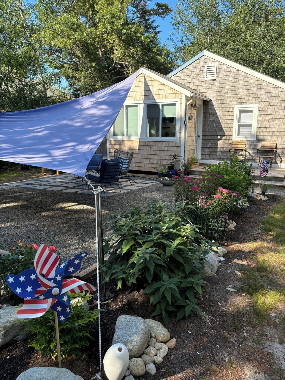 Front patio filled with flowering shrubs.