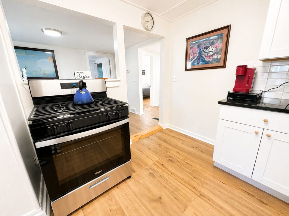Bright kitchen with stainless steel and coffee station—start or end your day
