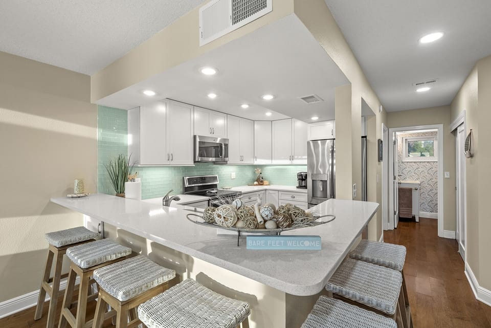 Stylishly remodeled kitchen, seats eight at the bar.