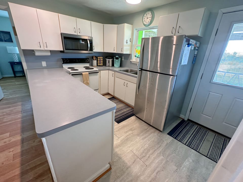 U-shaped kitchen with stainless fridge
