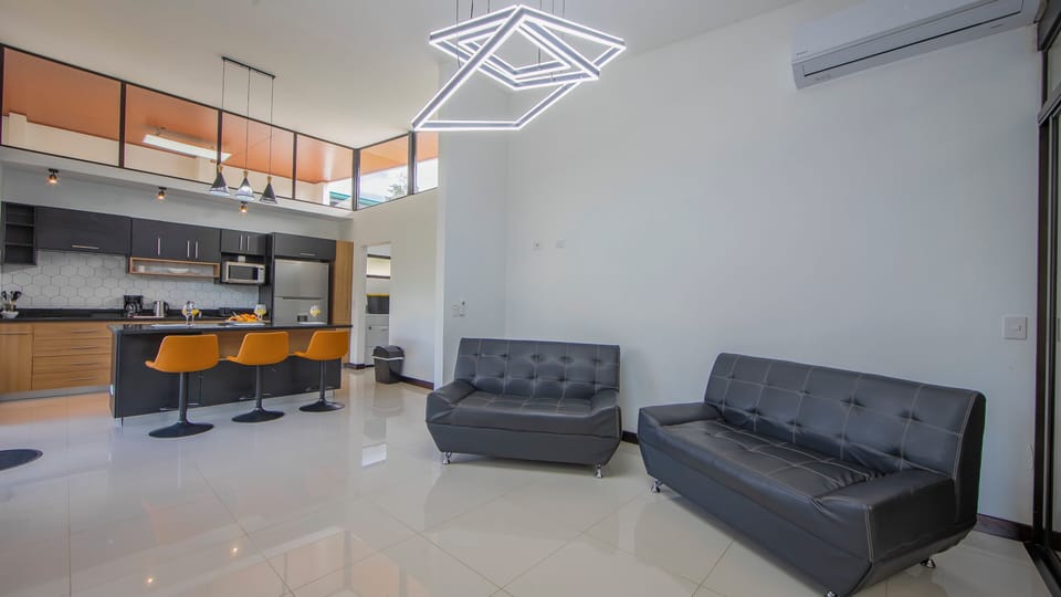 Living room and kitchen area with A/C unit, WiFi and Smart TV