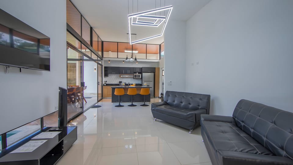 Living room and kitchen area with A/C unit, WiFi and Smart TV