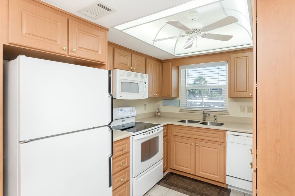 Fully equipped kitchen featuring modern appliances and ample cabinet space.