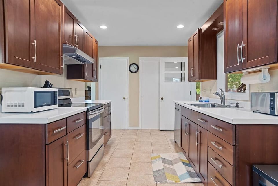 with stove, toaster, microwave, cups, bowls, plates, mugs, silverware and every cooking utensil you’d need (including barbecue tools)!