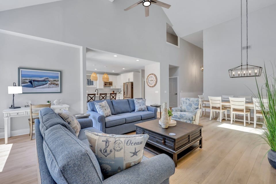 Living room with a flat screen tv and a sleeper sofa.
