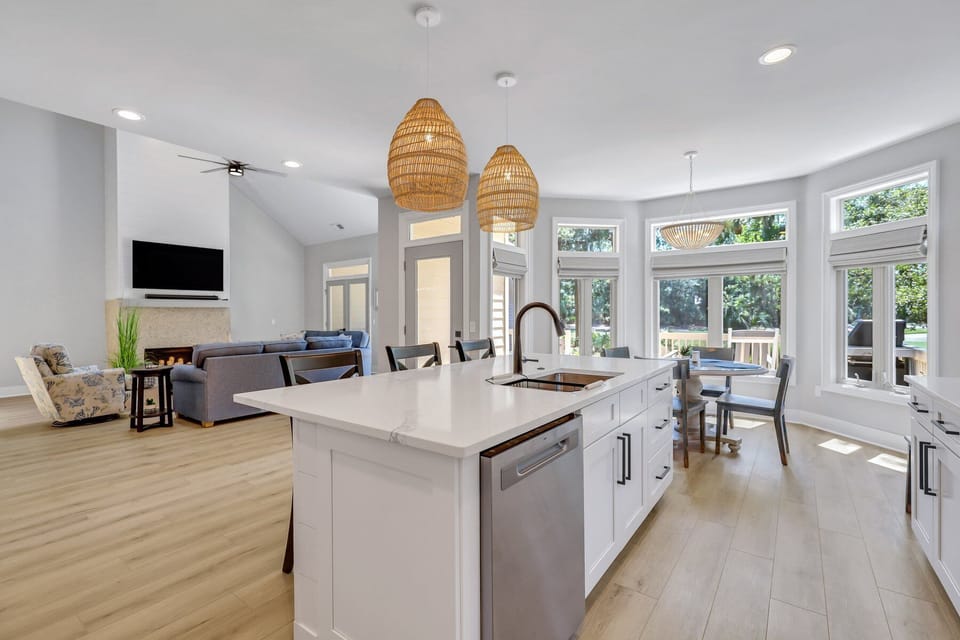 Fully stocked kitchen with stainless steel appliances and 3 barstools for extra seating.