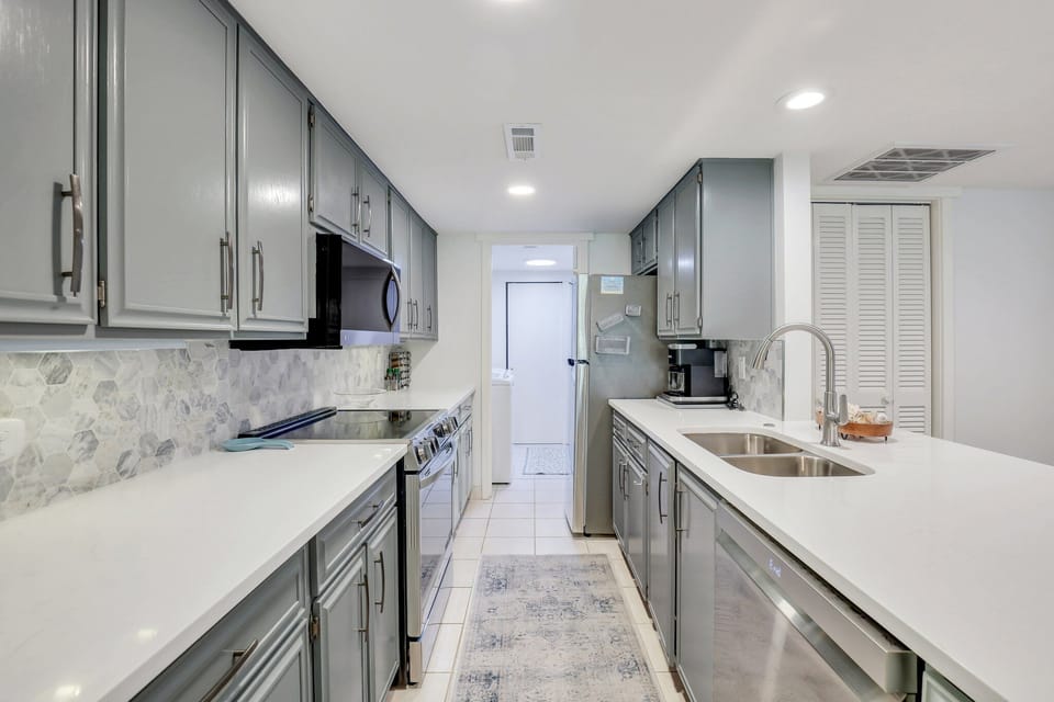 Kitchen with stainless steel appliances, fully stocked and featuring plenty of counter space.