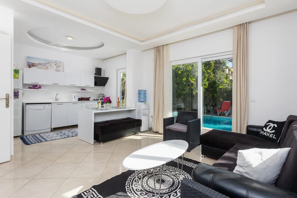 Open-plan living room with equipped kitchen, sofa, dining area,  A/C, WiFi internet, and satellite TV