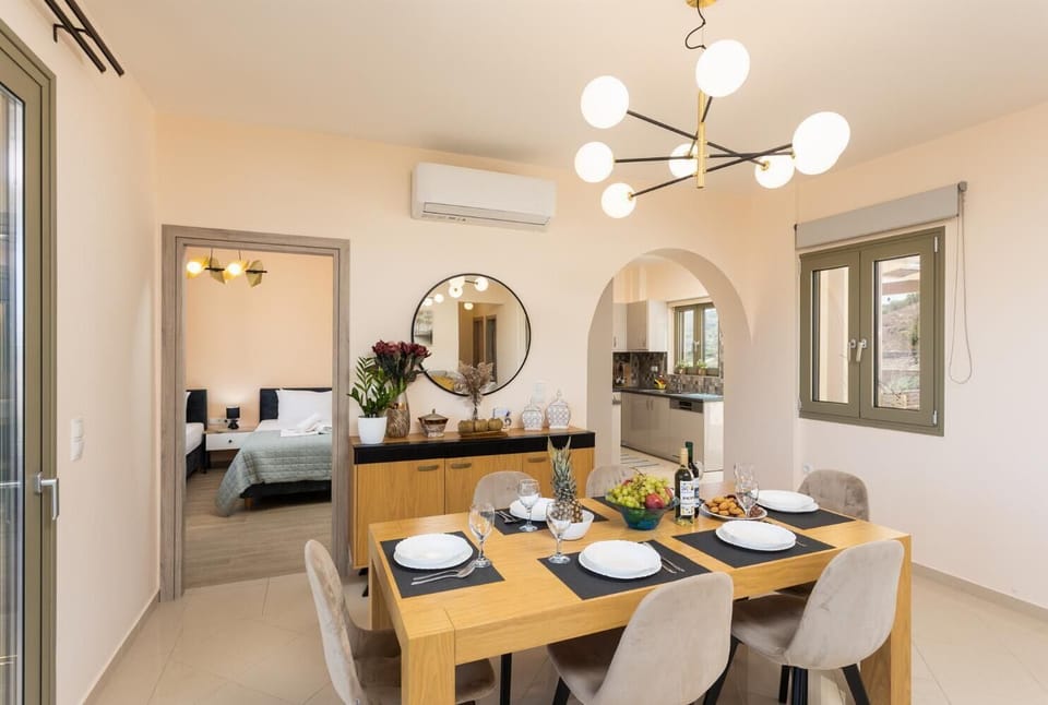 Open-plan living room with sofa, dining area, kitchen, A/C, WiFi internet, and satellite TV