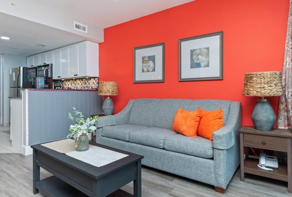 Bright living area with cozy sofa and open kitchen, perfect for relaxing