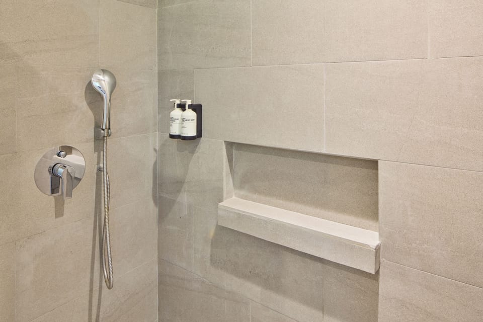 Shower, rainfall showerhead, hair dryer, towels