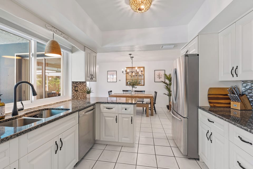 Open concept kitchen w/ plenty of cabinets.