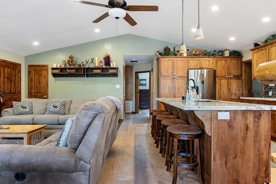Open spacious floor plan in which the kitchen opens up into the living room space.