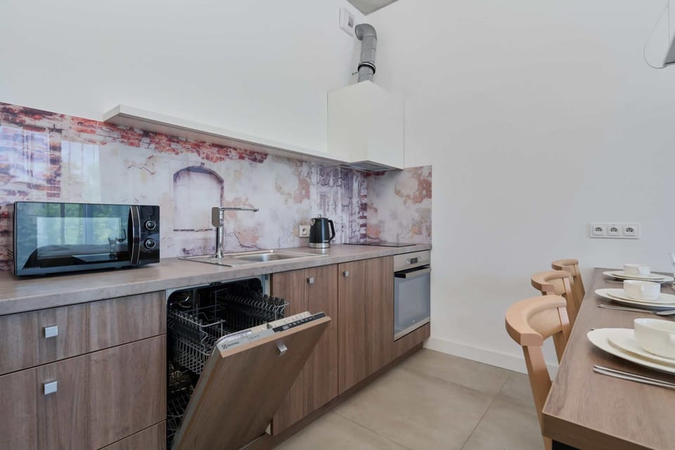 Fully equipped kitchen with wooden cabinetry, a sleek countertop, and modern appliances.

