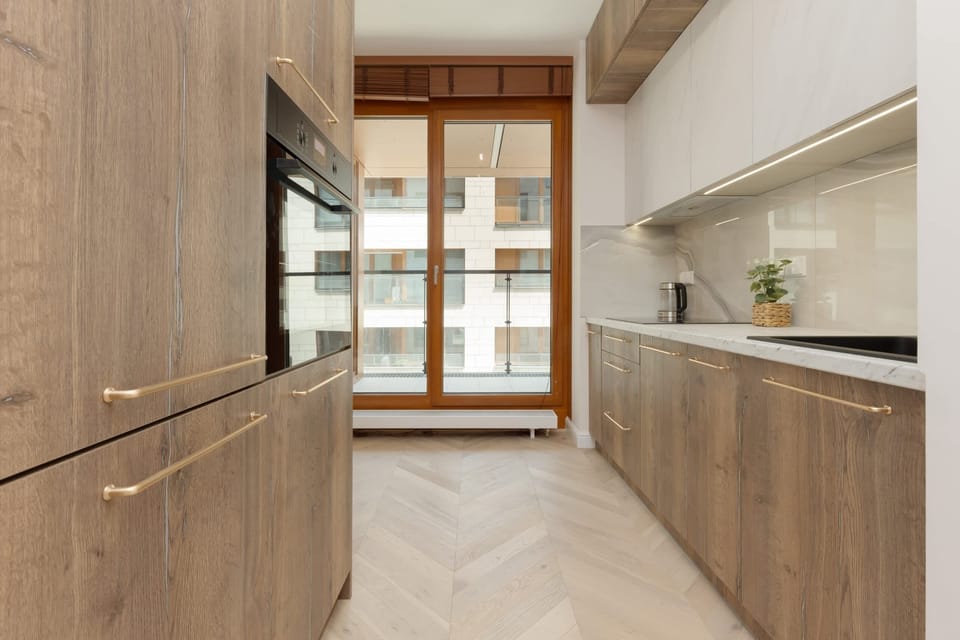 Kitchen space featuring ample counter space, modern fixtures, and natural wood finishes.

