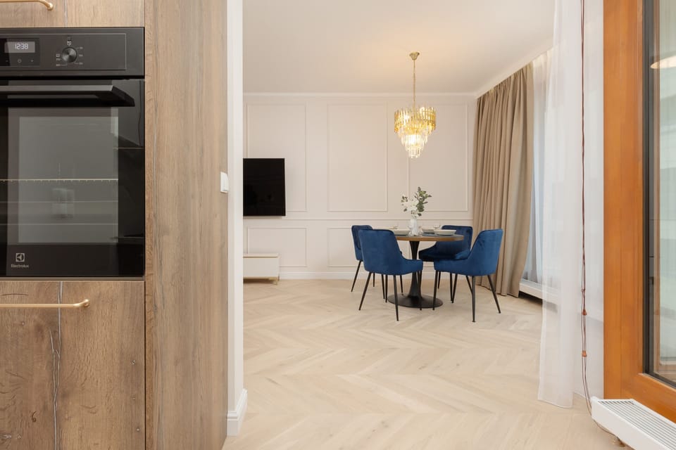 Built-in oven and wooden kitchen cabinets, creating a sleek and functional design.

