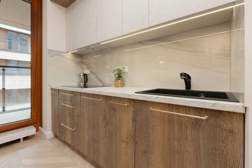 Full view of a contemporary kitchen with integrated appliances and elegant cabinetry.

