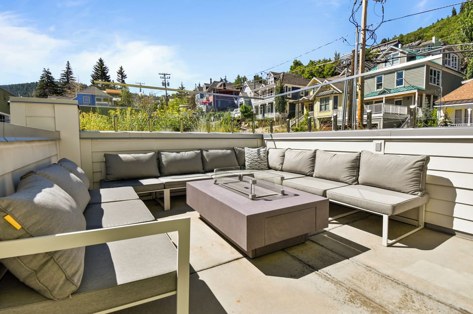 Comfortable seating surrounding your private fire pit on the balcony.