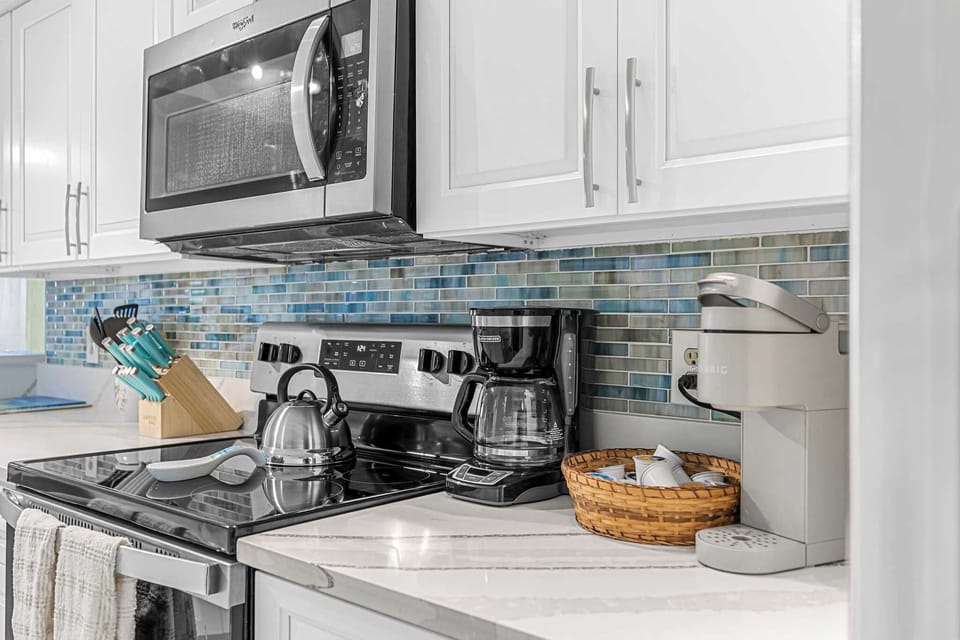 Modern kitchen with stainless steel appliances and a colorful tile backsplash