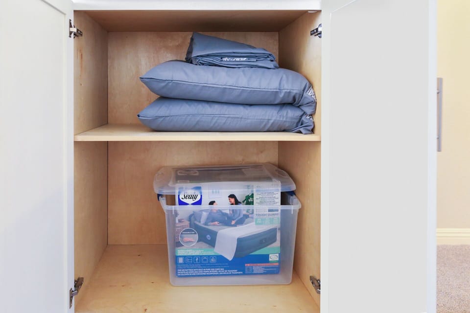 Queen air mattress and bedding in the living room