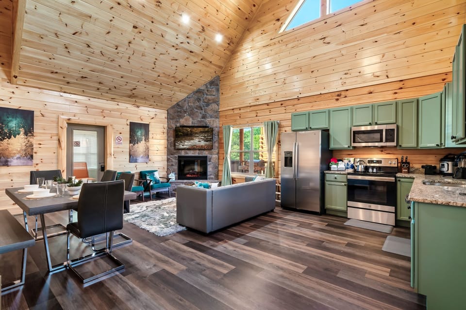Living Space: Bright and airy retreat with modern kitchen and inviting stone fireplace!