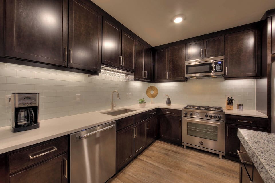 The gorgeous kitchen features granite countertops, stainless steel appliances, and everything you'll need to whip up a tasty meal.