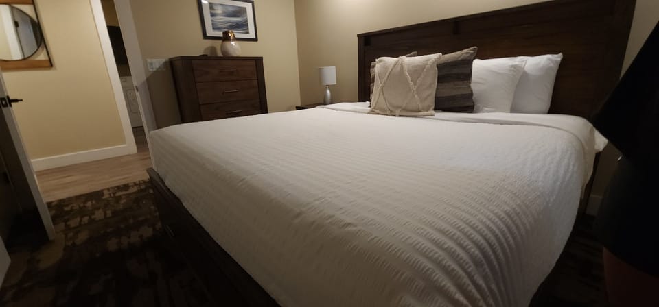 The inviting third bedroom provides a high end king bed for a great nights sleep.