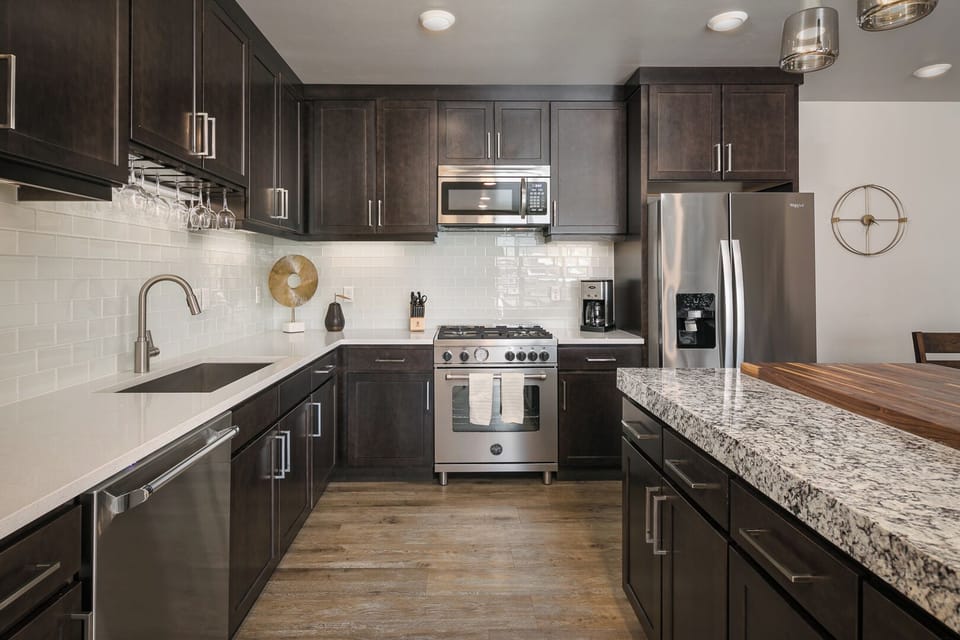 The gorgeous kitchen features granite countertops, stainless steel appliances, and everything you'll need to whip up a tasty meal.