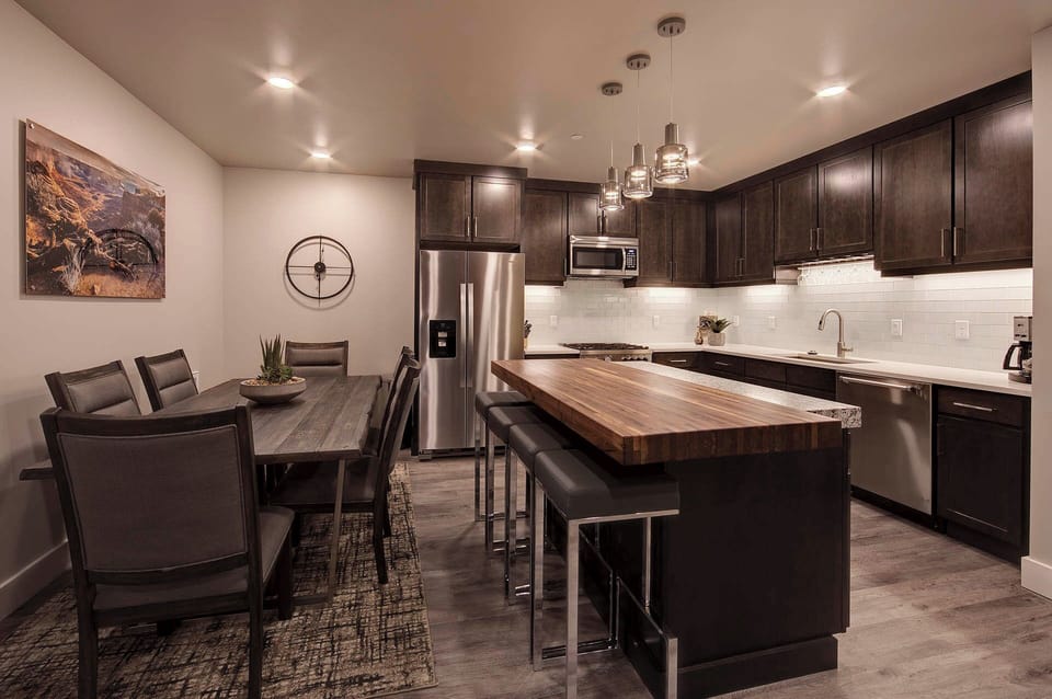 Plenty of seating options available at the dining table or kitchen island. (Photos don't depict actual furnishings in the unit)