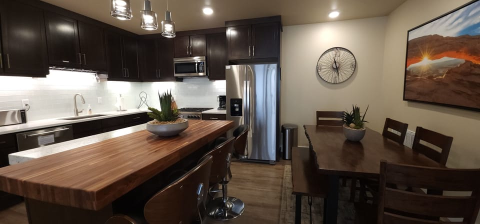 Plenty of seating options available at the dining table or kitchen island.