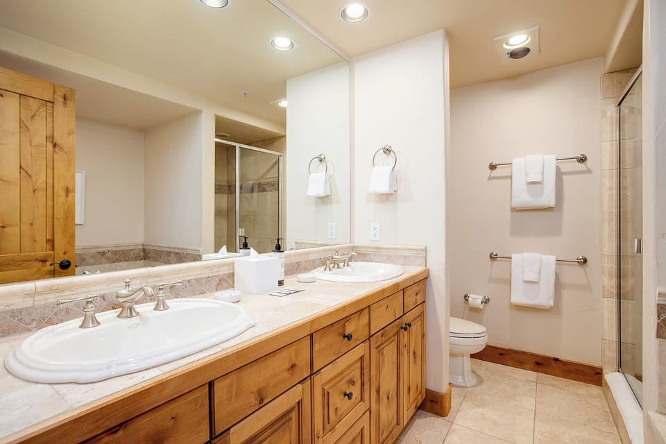 Unwind in your beautifully appointed bathroom with double vanities, elegant stone counters, a walk-in shower, and plush towels awaiting you.