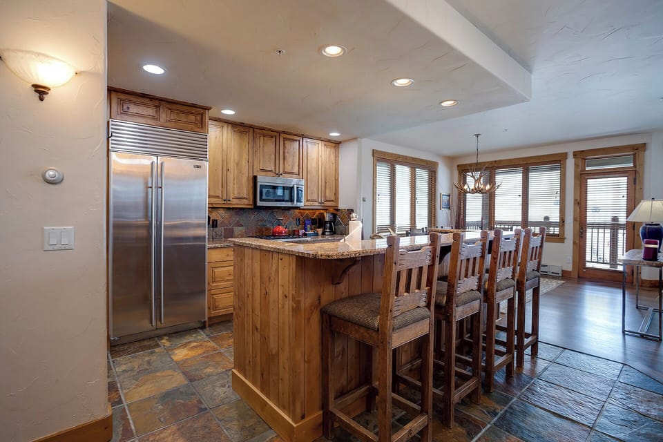 Your fully-equipped kitchen features granite countertops, stainless steel appliances, and a breakfast bar where you can start each morning with coffee.