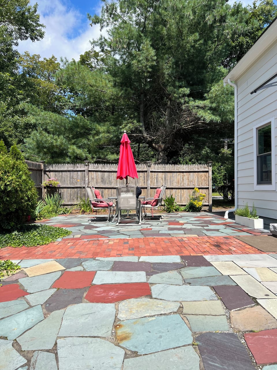 Patio with fireplace and fire wood on the property. Lots of seating