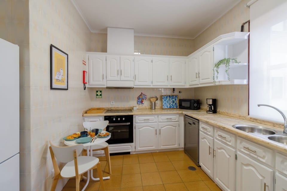 Fully equipped kitchen with dishwasher, stove/oven, and breakfast table.