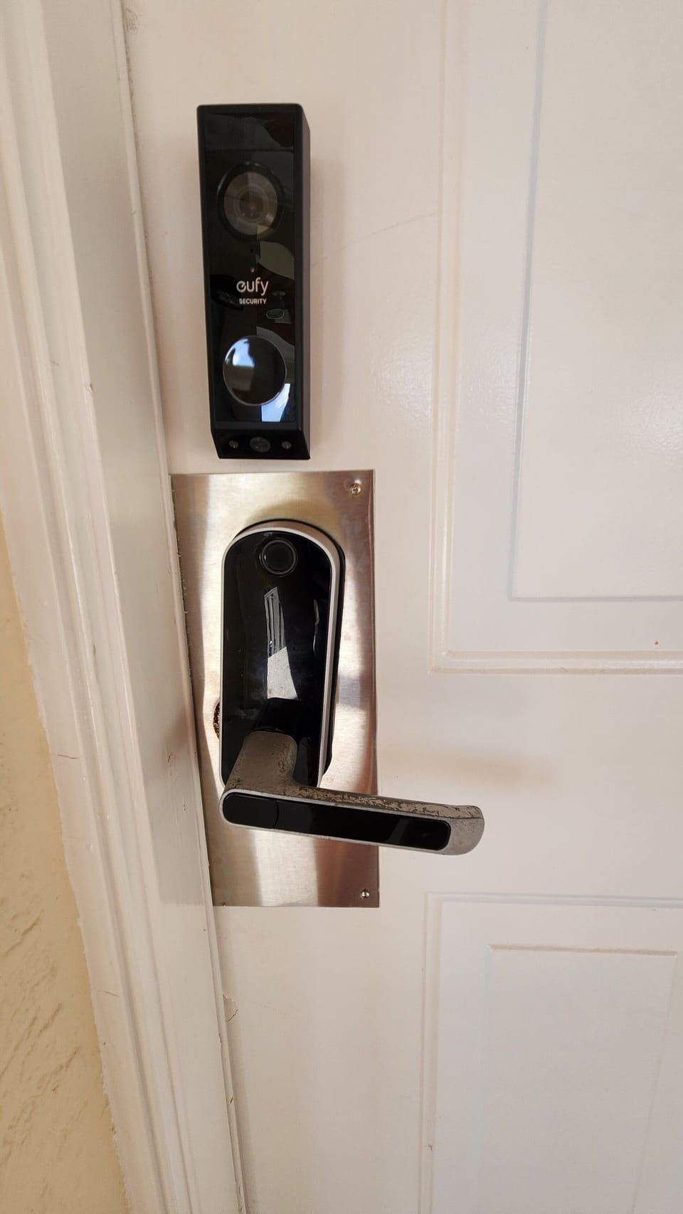 Tap screen above handle for numbers to light up to enter code. there is a door camera above to monitor for pets and number of guests. 