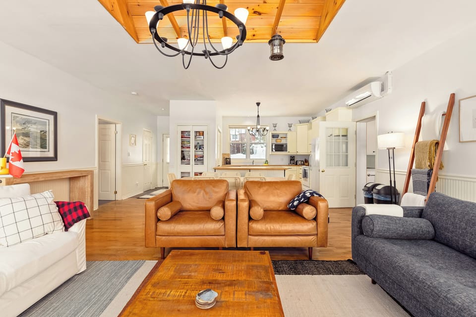 The living room is connected to a bright, spacious kitchen. 