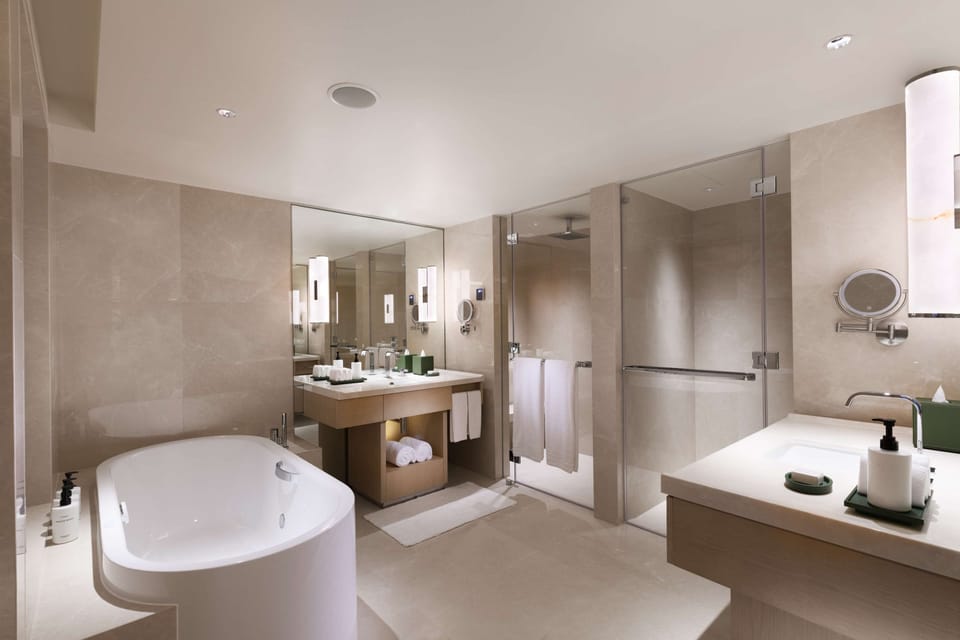 Conrad Suite with Lounge Access, 1 King Bed | Bathroom | Shower, hydromassage showerhead, eco-friendly toiletries, hair dryer