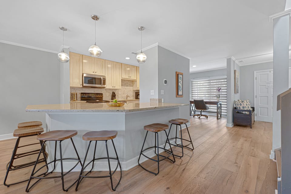 The dining area and breakfast bar offer ample seating, making this space both functional and welcoming for everyday living.