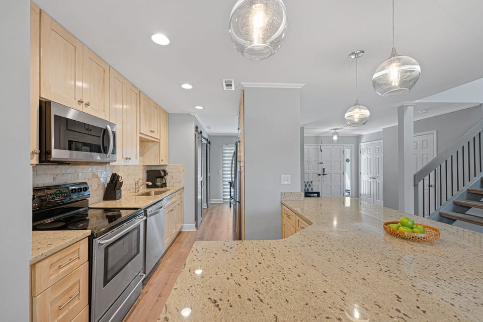 This beautifully updated kitchen anchors the main living space with an oversized breakfast bar ideal for casual dining and entertaining.