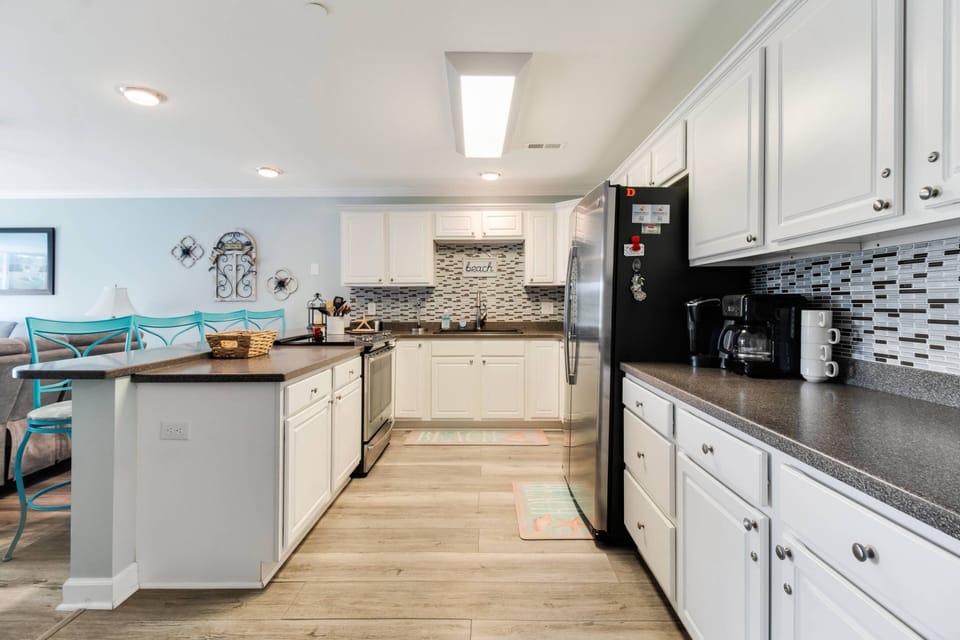 Spacious kitchen with stove, microwave, dishwasher and refrigerator