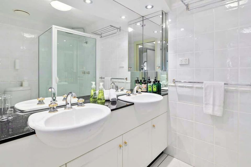 Refresh and recharge in the ensuite, where dual vanities and a walk-in shower provide extra space for getting ready before a day of exploring Cairns.