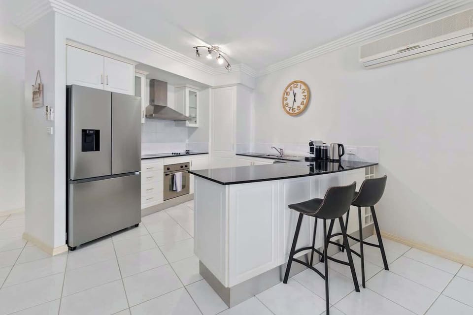 Start the day with coffee at the breakfast bar, where stone benchtops and casual seating provide the perfect place to plan your Cairns adventures.