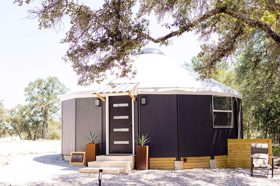 Private modern yurt tucked under Hill Country oak trees.