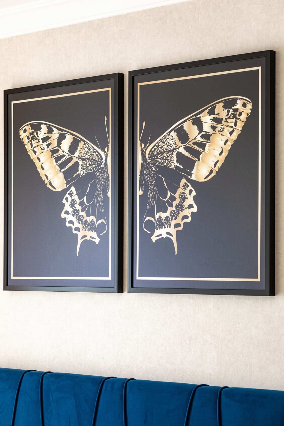 Close-up of butterfly-themed wall art, adding charm to the bedroom.

