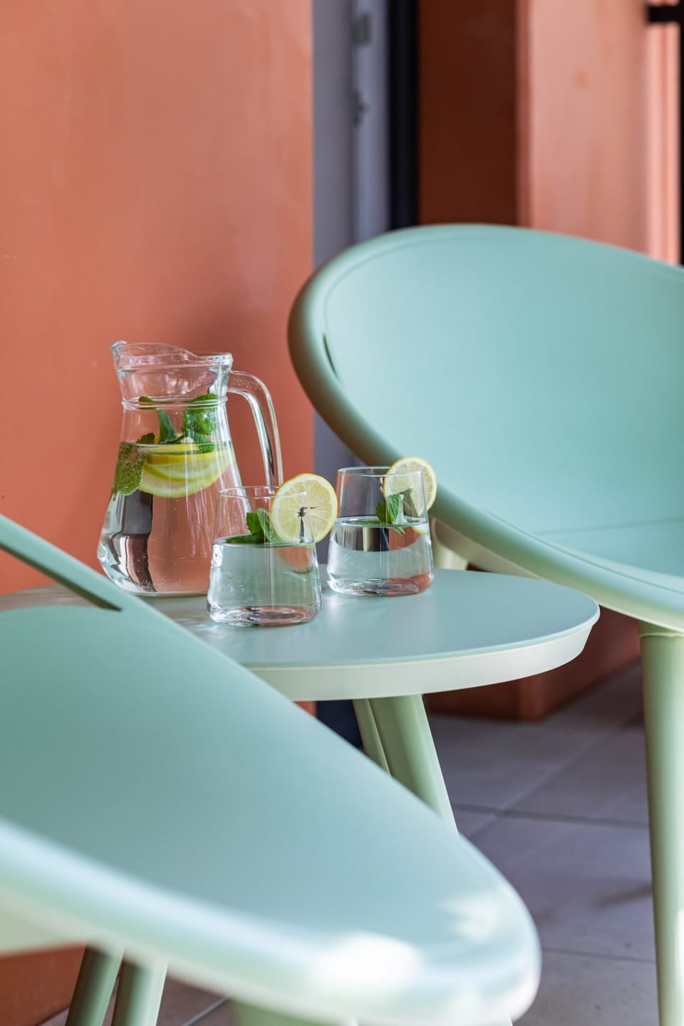 Outdoor table with refreshing drinks and modern seating, perfect for relaxation.

