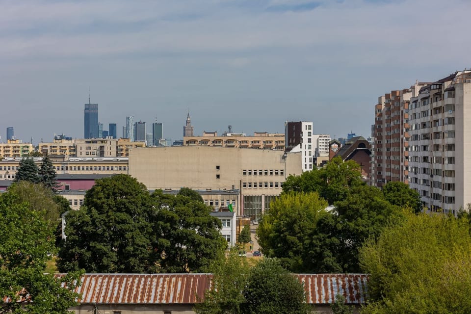 Scenic city view with lush greenery and buildings in the background.

