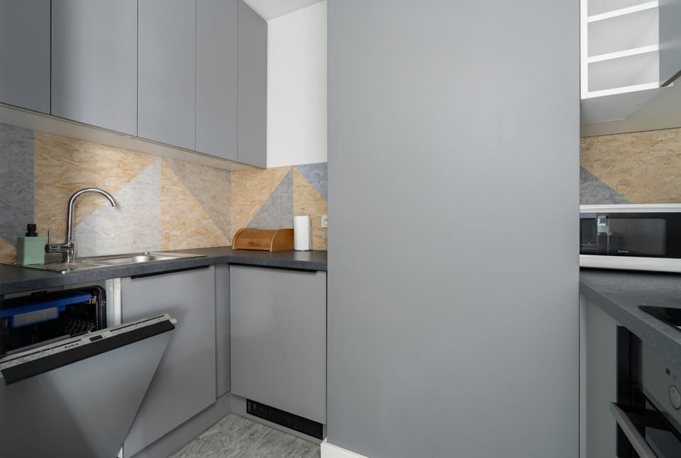 View of the dining and kitchen area with a clean and cohesive modern design.

