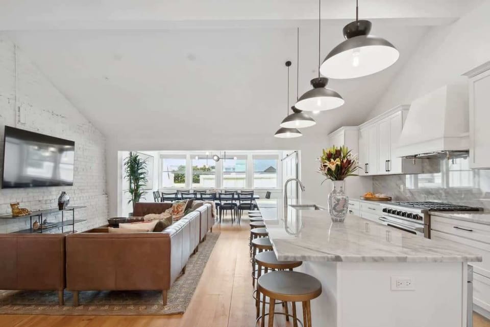 Welcome! Kitchen and Living Dining Area | Open Concept Layout with Large Seating Island for Eight Guests